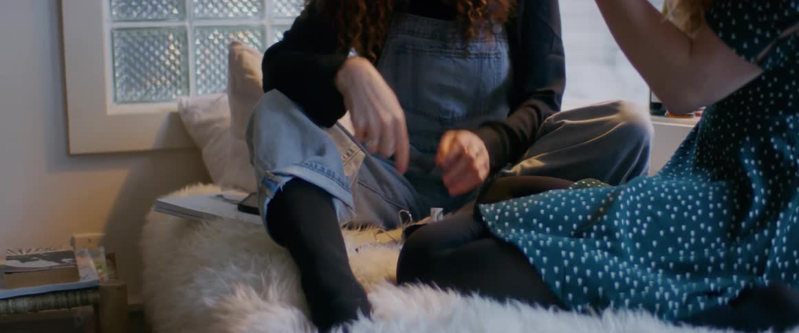 Two women putting on makeup together