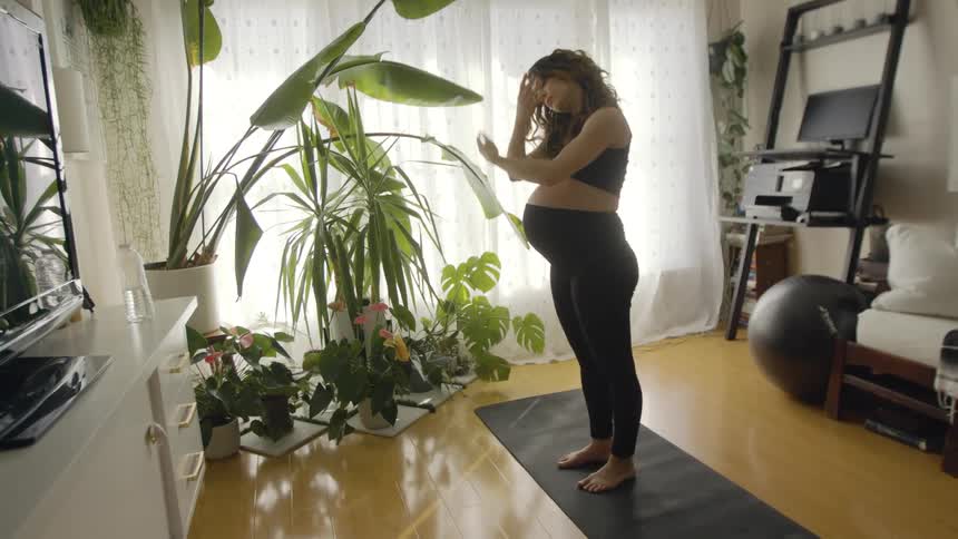 A woman doing yoga and stretching indoors