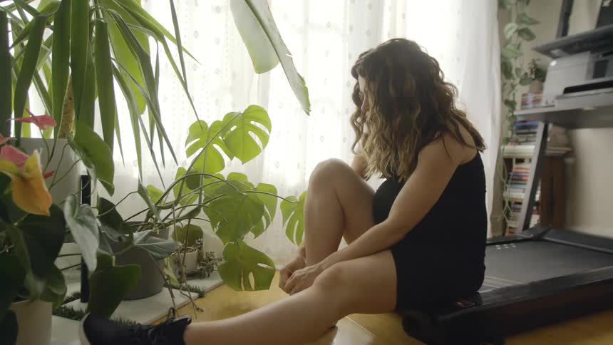 A woman putting on shoes to workout