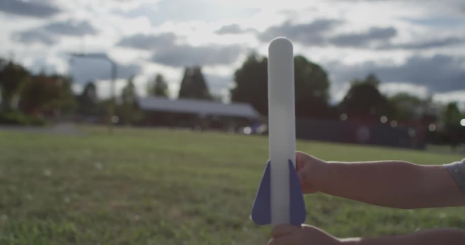 A child puts a rocket on a pole