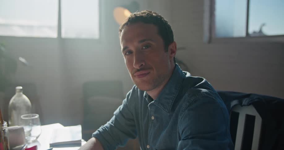 A man is sitting at his desk