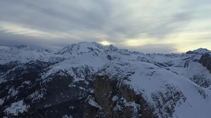 Snow covered mountains under a cloudy sky