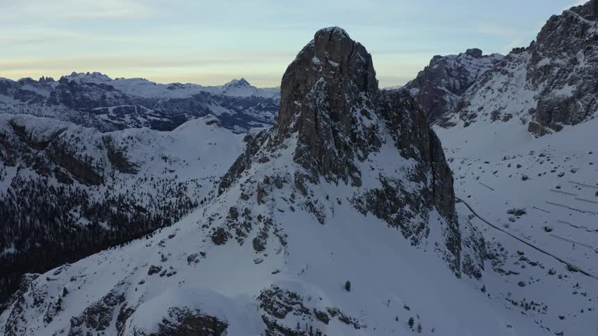 Mountain tops peek out under a blanket of thick snow