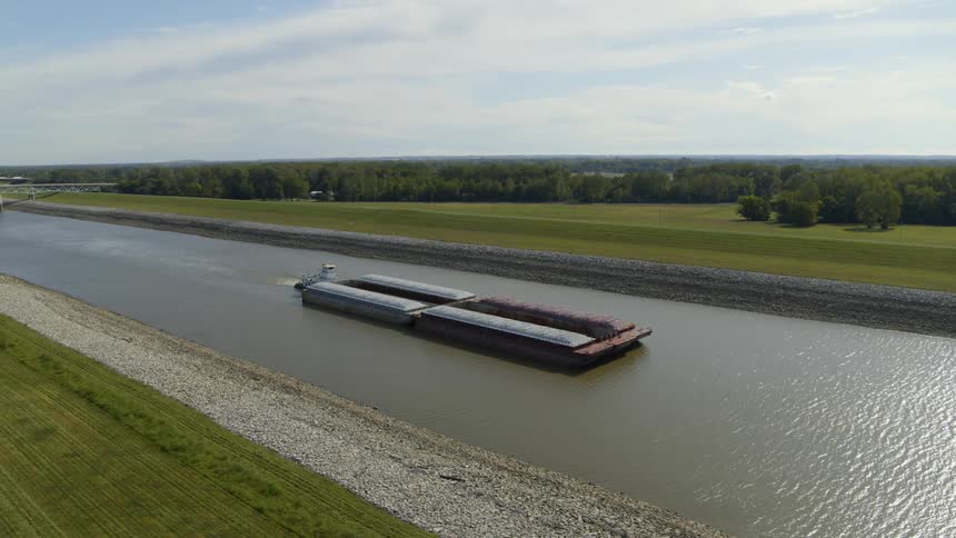 A barge travels along an inland canal