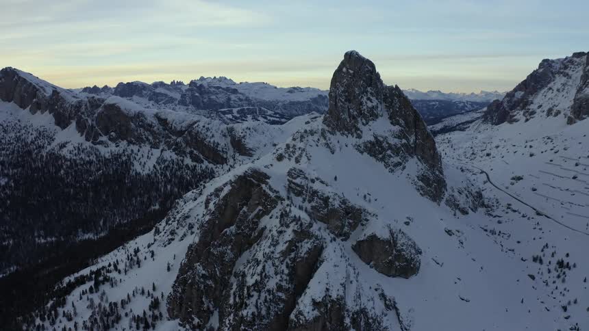 Aerial view of high snowy mountains at dusk