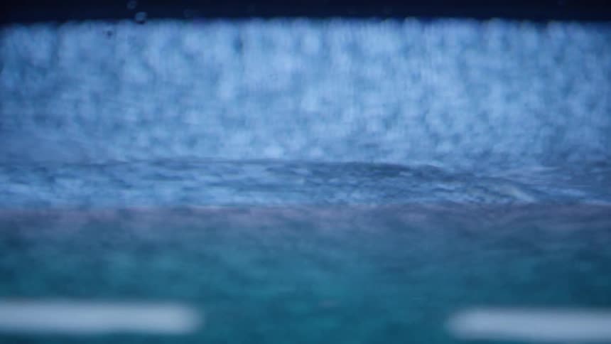 Water quickly fills the inside of a glass container