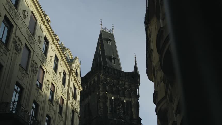 View of a cathedral in a city looking up from the street level during the day