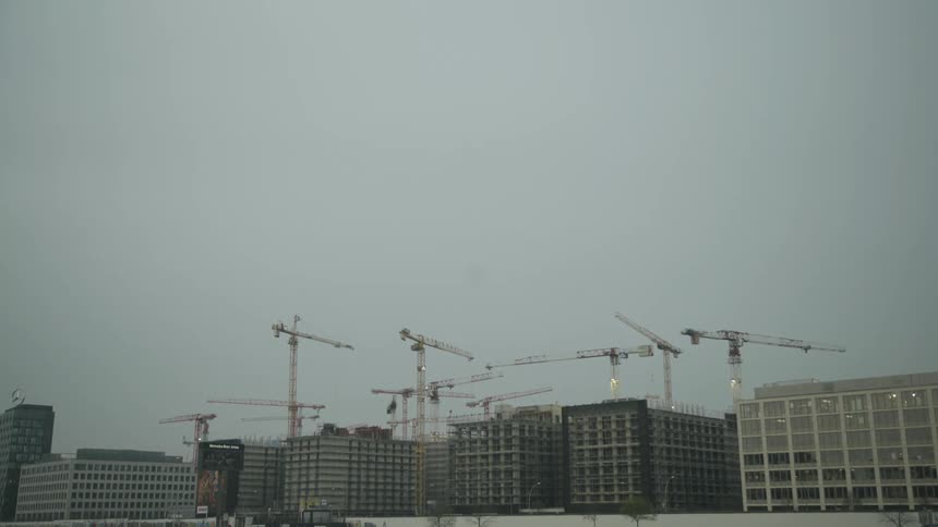 Construction cranes working high above buildings