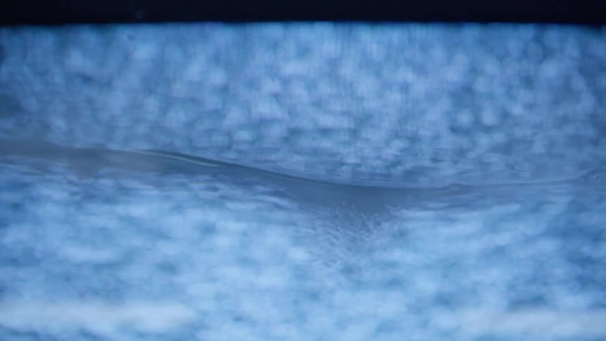 Blue white and gray colors that look like running water with bubbles