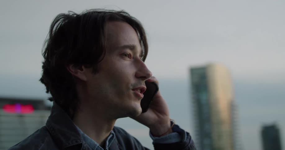 A man is talking on his cell phone outside