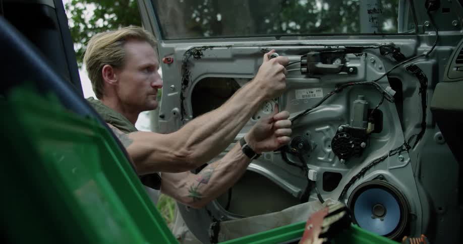 A man is working on his vehicle