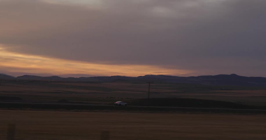 A view of a car driving down a road