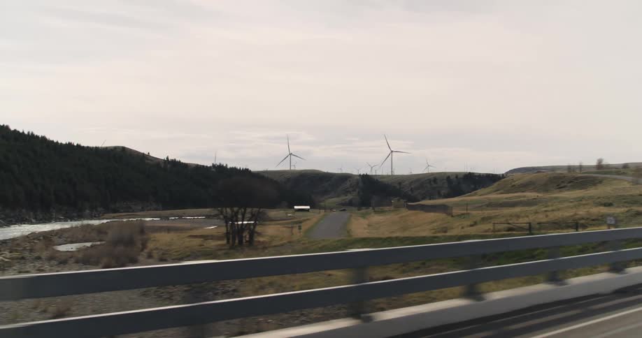Wind turbines produce electricity on wind farm next to hydroelectric power