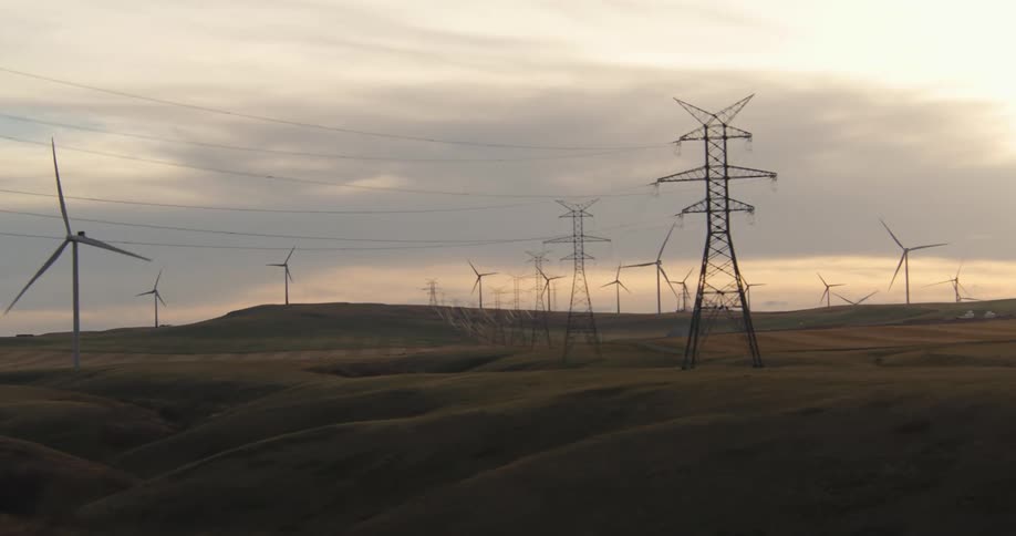 Windmills and power lines cover the hills