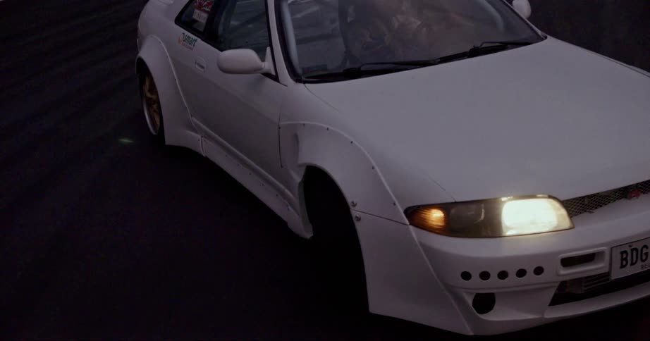 A driver struggles around a curve on a track