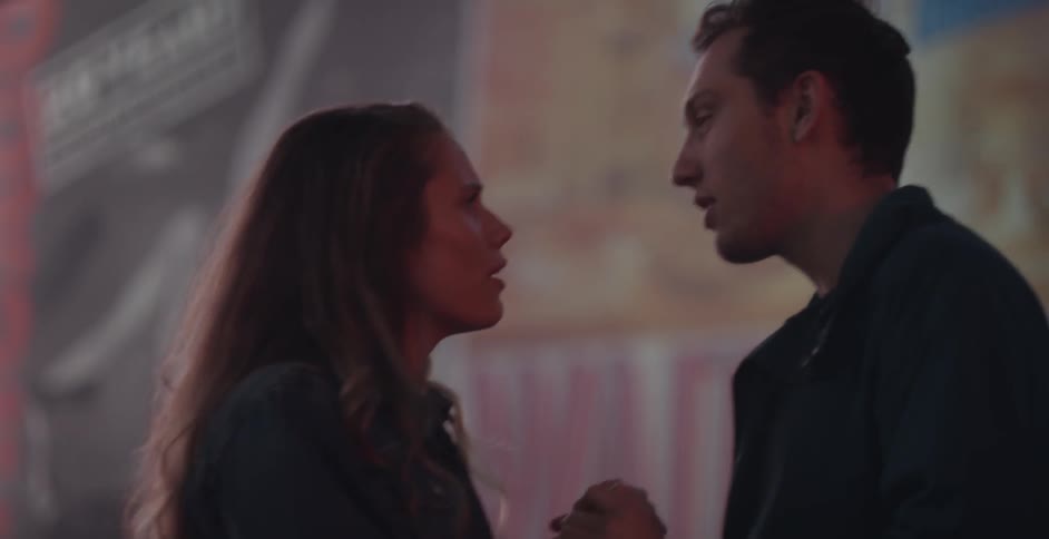 A man is twirling a woman in his arms before setting her down