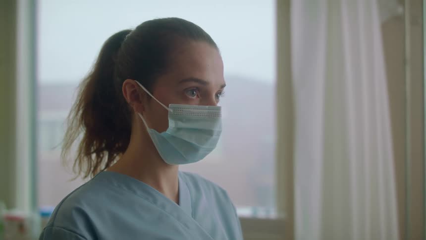 A woman nods and walks away in the hospital
