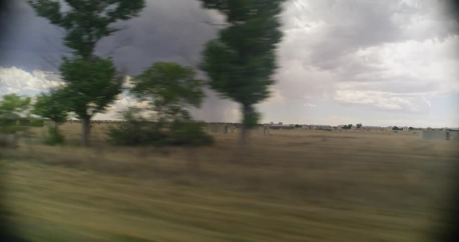 A storm is moving in the distance on the field