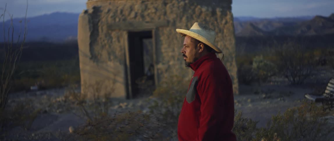 A man standing outdoors in the desert