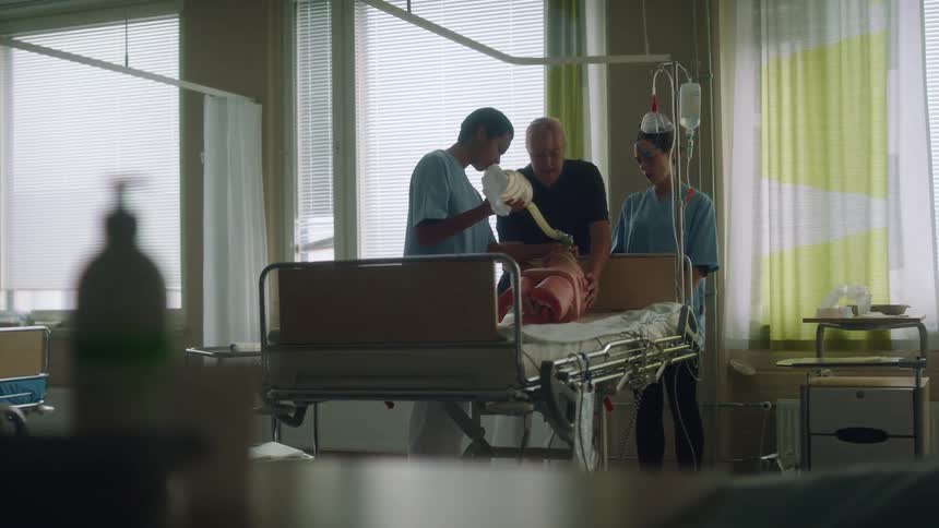A nurse uses a pump to inflate a device for a patient