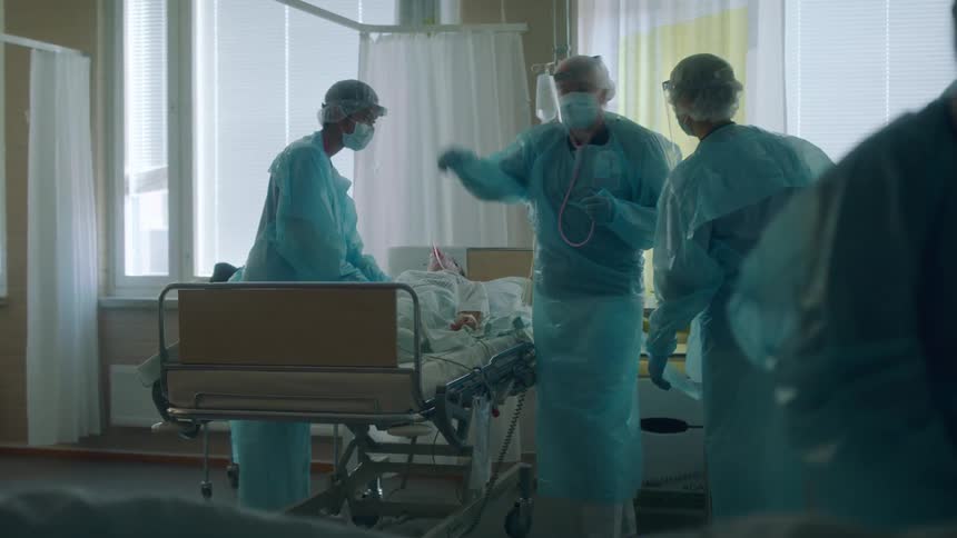 Doctors work on a patient in the emergency room