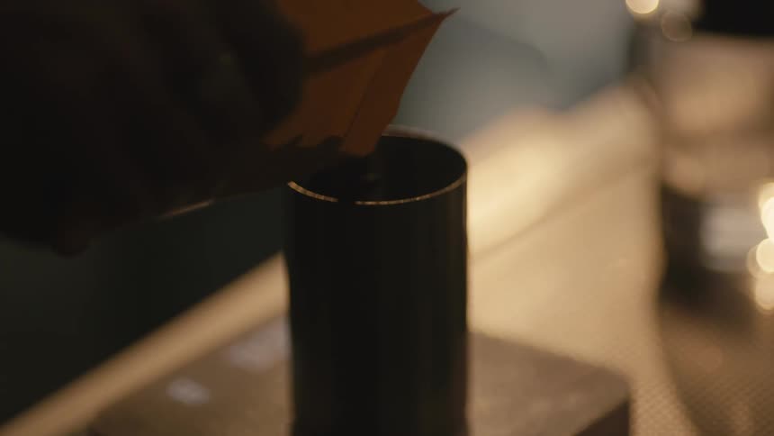 A person measuring out coffee beans