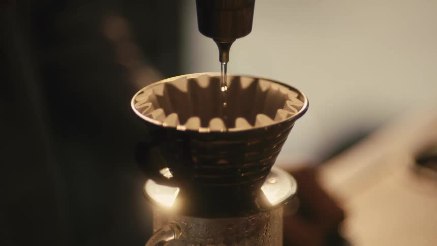 Water pours into a filter to brew coffee