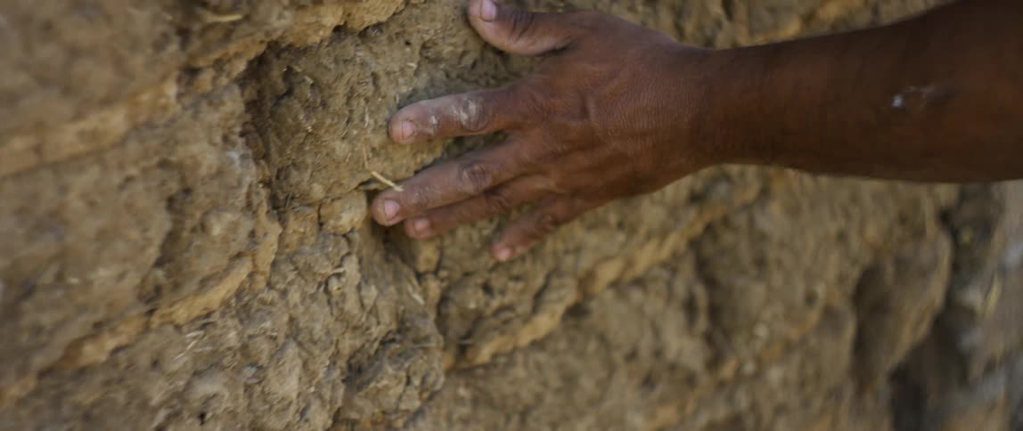 Person dragging hand on wall