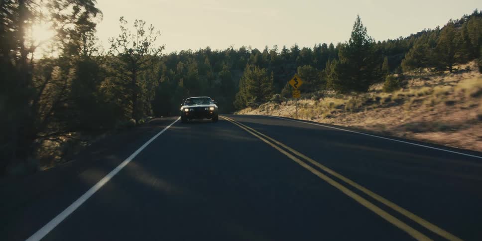 A car driving down a mountain road