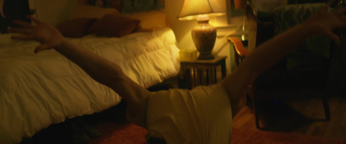 A man dancing in a bedroom