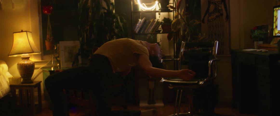 A man dances in his apartment