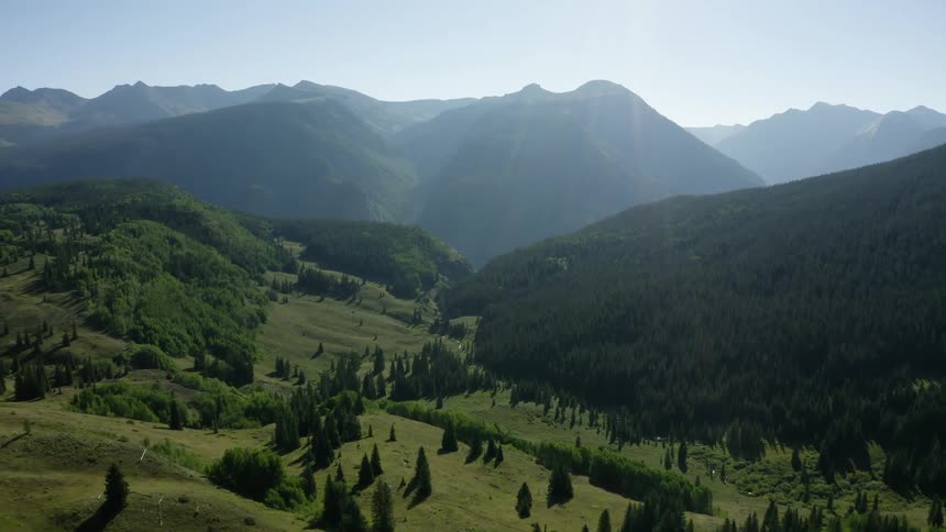 Trees line a valley that is very lush