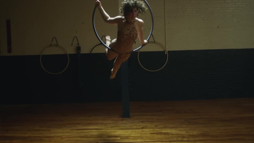 A woman spins in a ring as she performs acrobatics