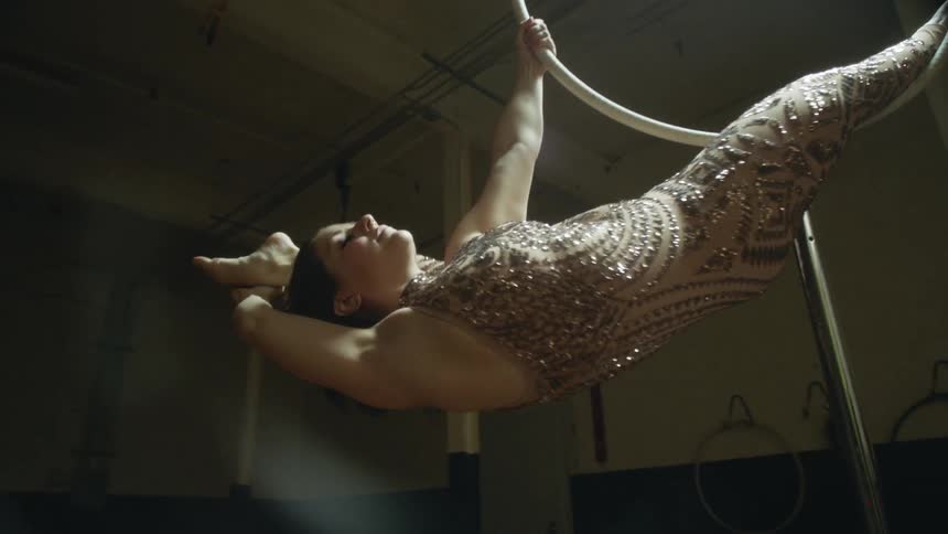 A woman doing gymnastics on a large ring