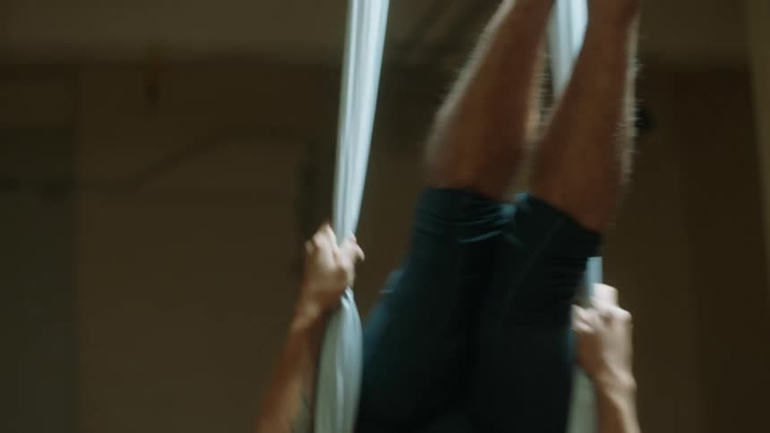 A man doing acrobatics indoors