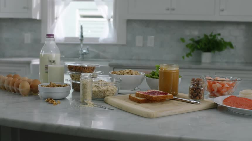 Toast cereal and other breakfast foods are laid out on a kitchen island