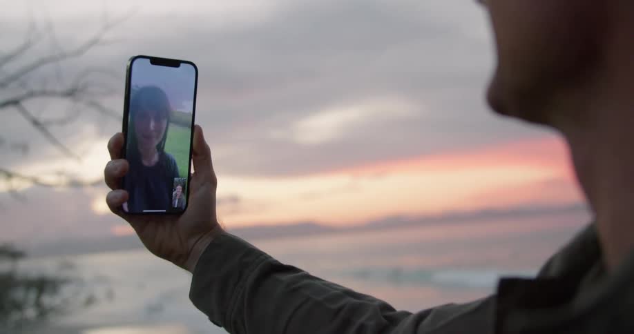 A man talking to a woman on a smartphone