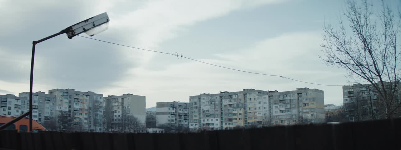 A field sits before the apartment complex