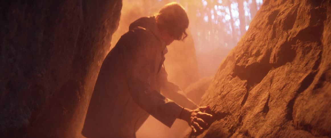 A man walking around in a canyon