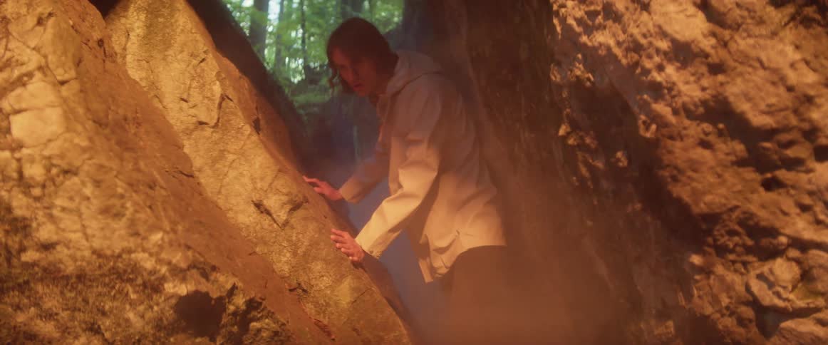 A man walking into a cave