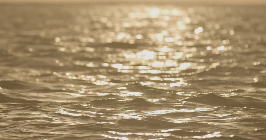 Sun's reflection on golden water
