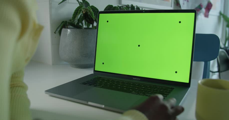 A man works on his laptop at his desk