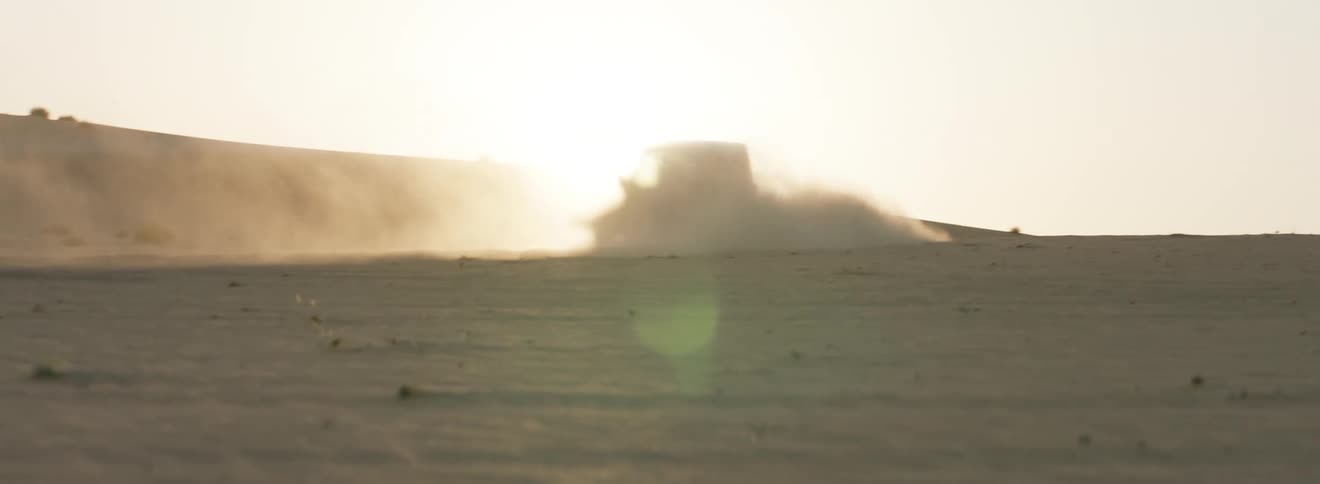 A vehicle is turning in the desert