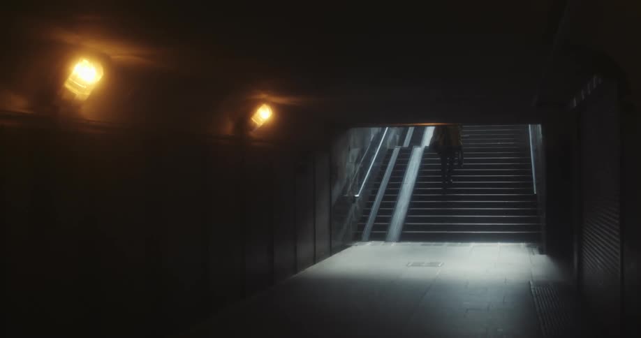 People go up and down dark underground stairs