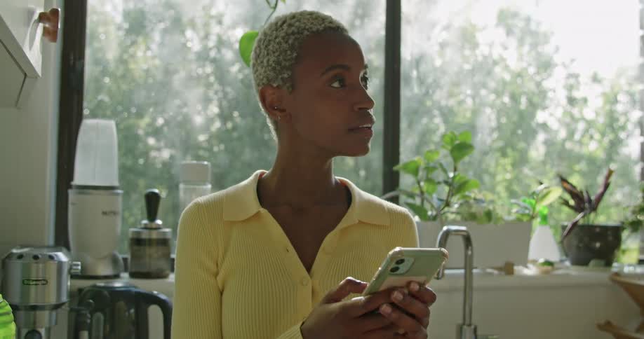 Black female typing on phone