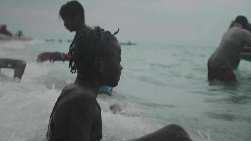Cdhildren and adults playing in water
