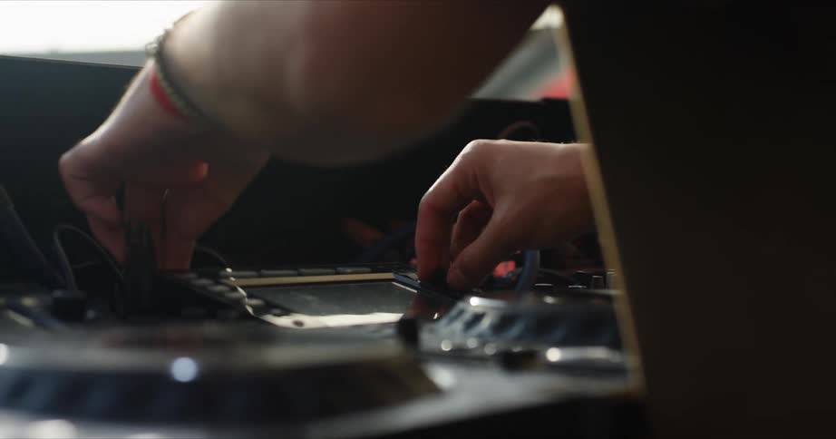 A man is turning dials on some equipment