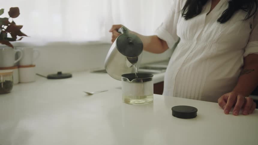A woman pouring water into a device