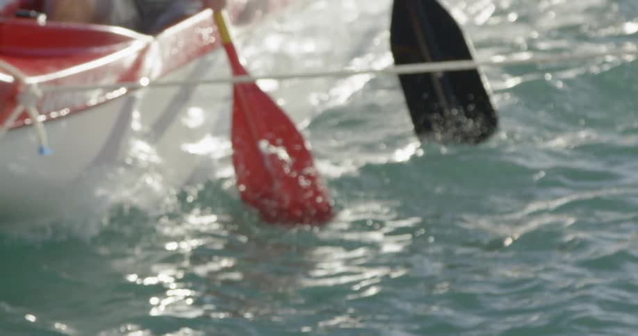 Close-up of oars being used to paddle a rowboat