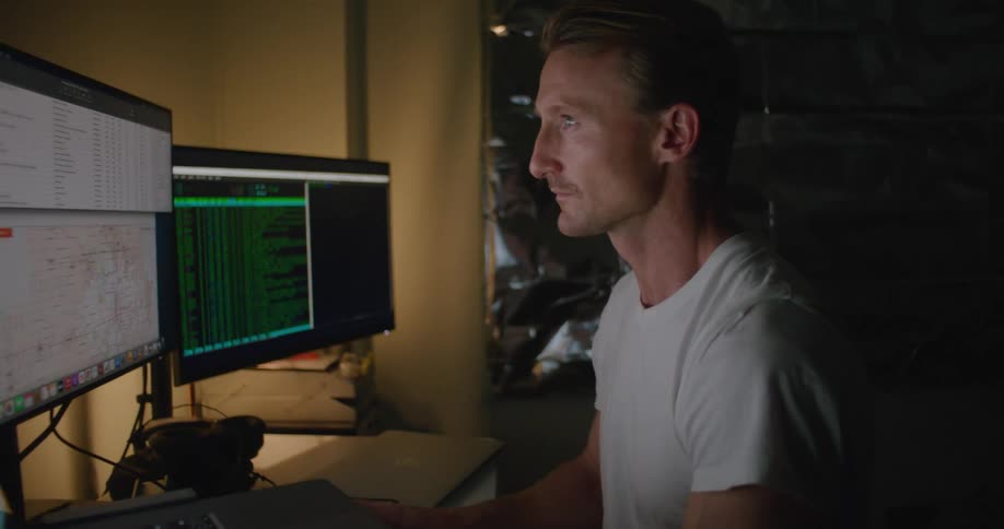 A man working in an office in front of a computer